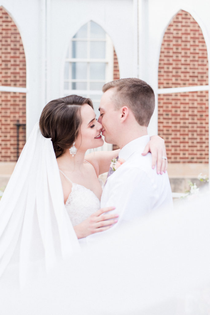 pretty in pink styled shoot bride and groom veil shot