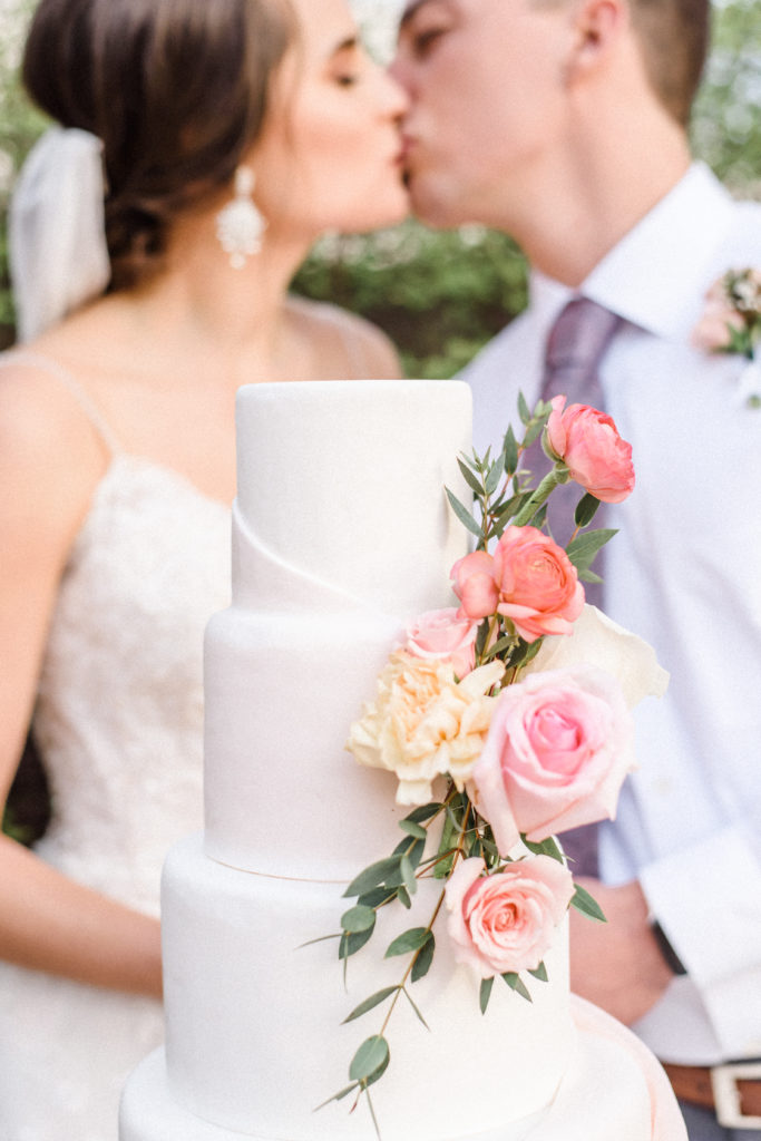 pretty in pink styled shoot bride and groom with cake