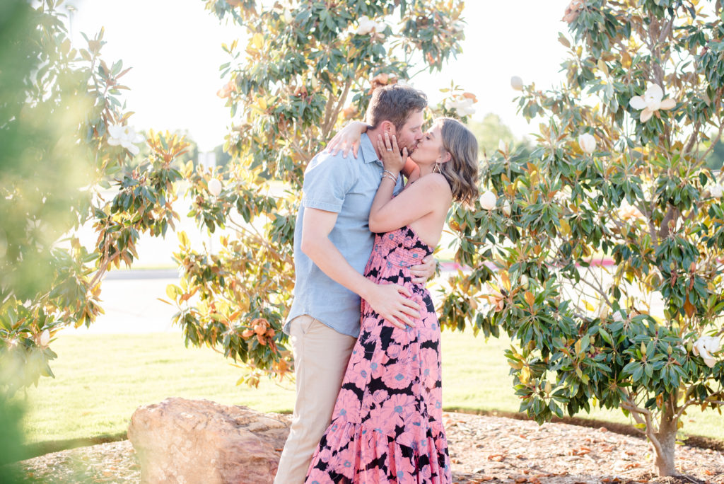 couple kissing by a tree