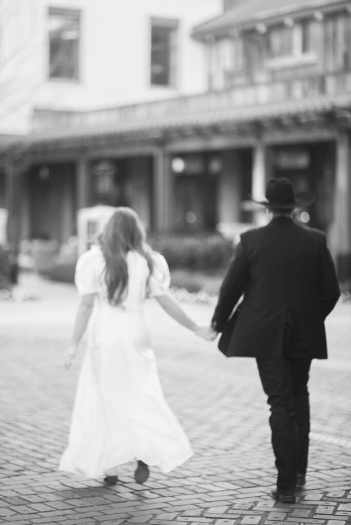 couple walking in black and white