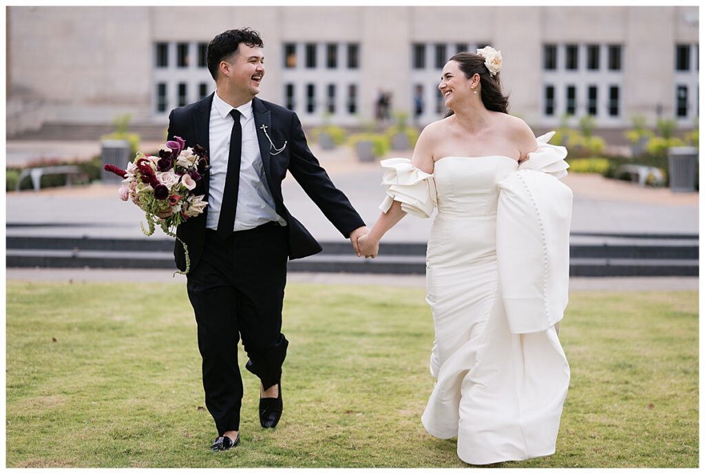 bride and groom running at civic center music hall