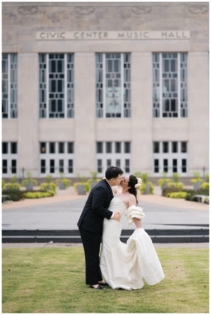 bride and groom in front of civic center